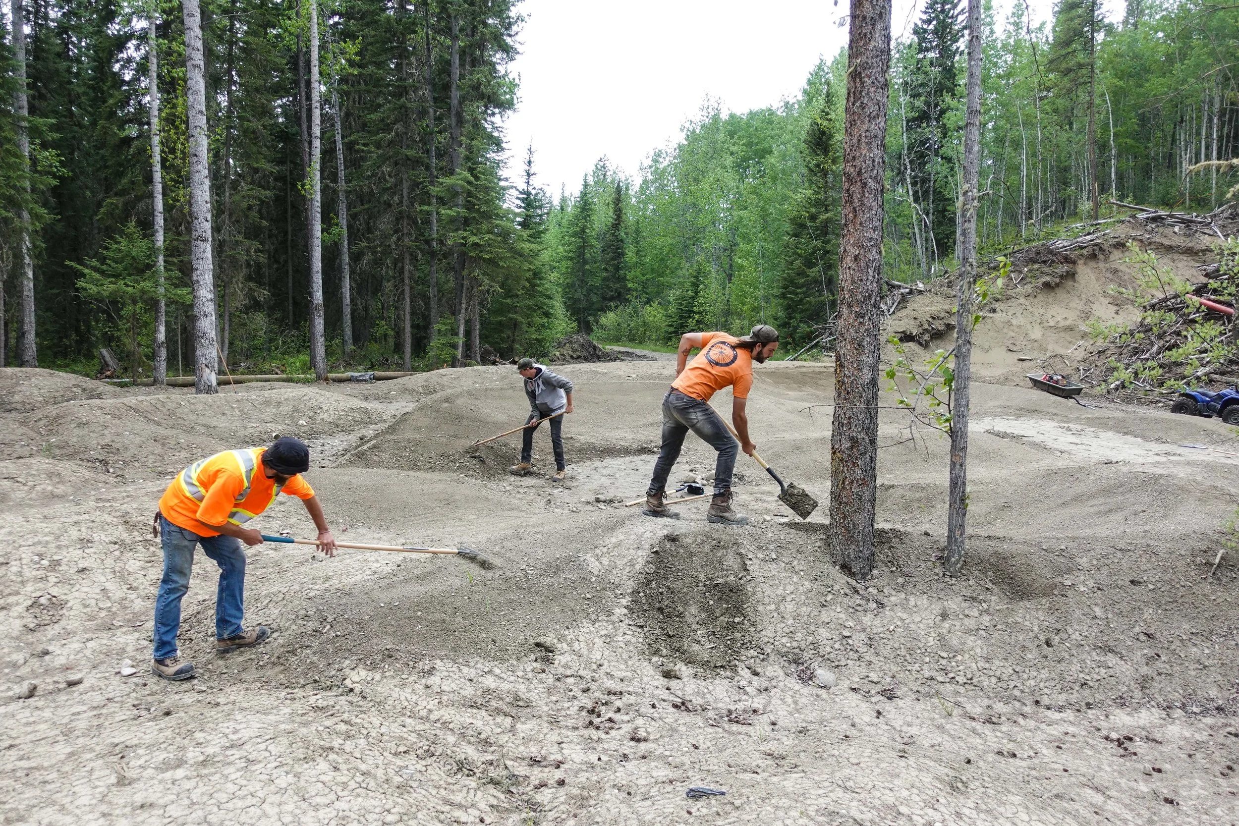 Part of the 2019 Hoots Inc crew. - Raking limestone screenings into the advanced pump track area.