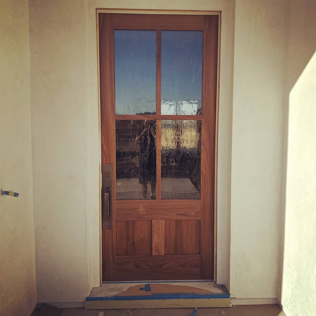 Here's a great example of a simple yet elegant, modern-rustic custom Entry. 
3/6 x 8/0 Simpson Walnut Entry Door with an Ashley Norton Urban Mortise Entry Set. 
A warm American classic Walnut wood species, paired with an organic Seedy Baroque glass p