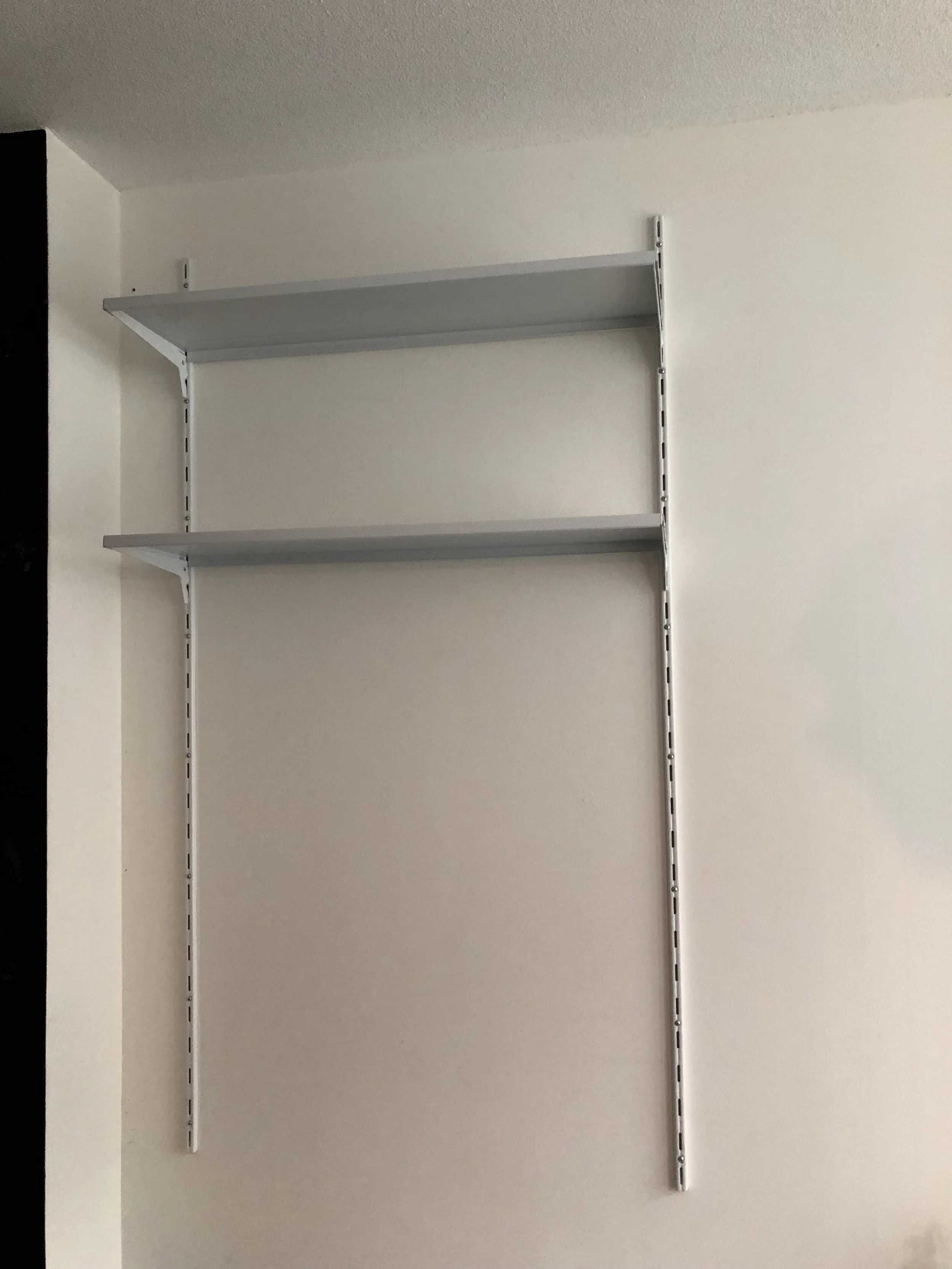 Finish up drilling in second bracket, place shelf hooks where wanted and add shelves.&nbsp;