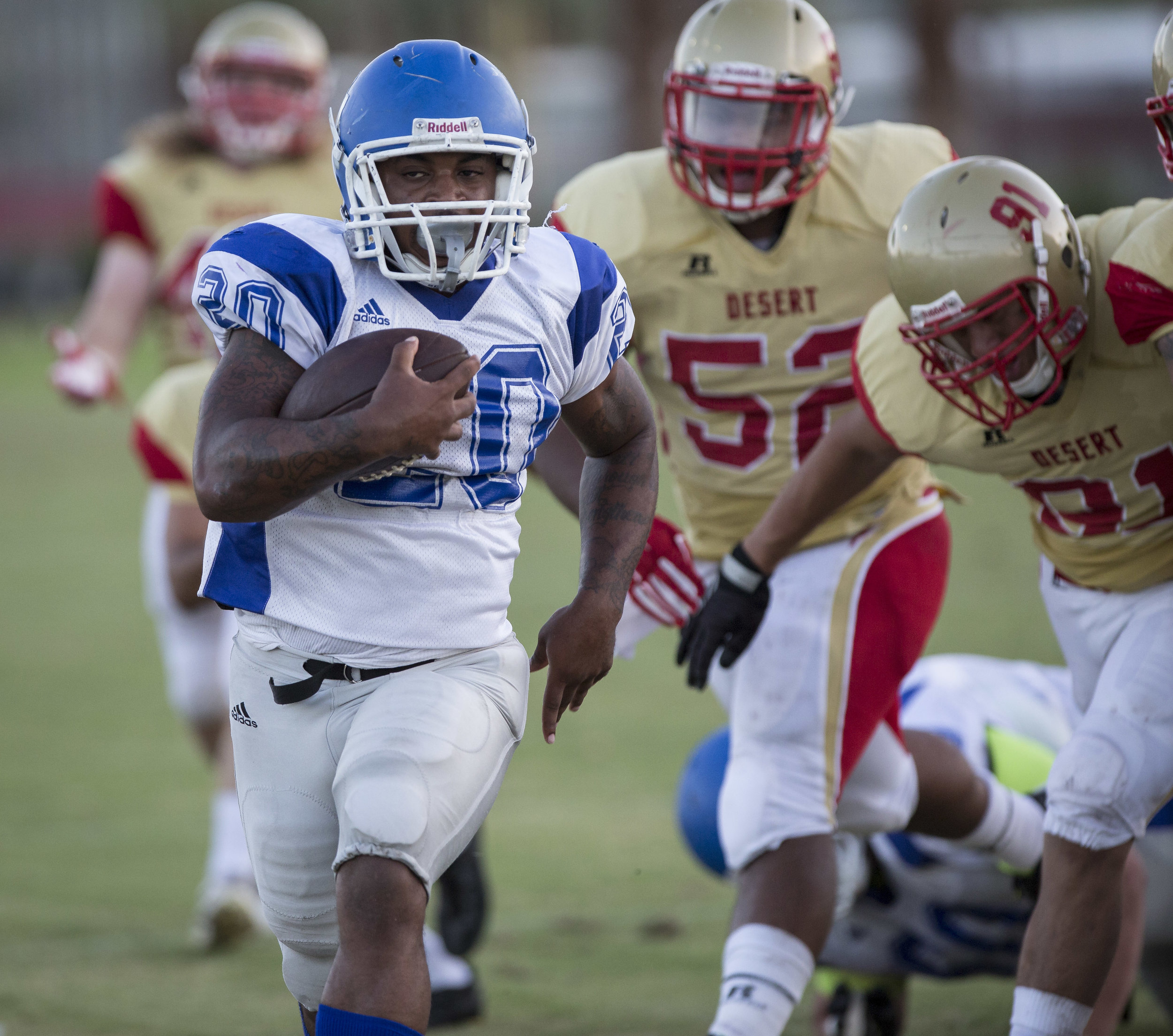  The Santa Monica College Corsairs sophmore running-back #20 Roger Jones (In White,Left) runs past defenders from the College of The Desert Roadrunners to score a 31 yard touchdown in the 2nd quarter of play. The Corsairs would win 68-25. Desert Spri