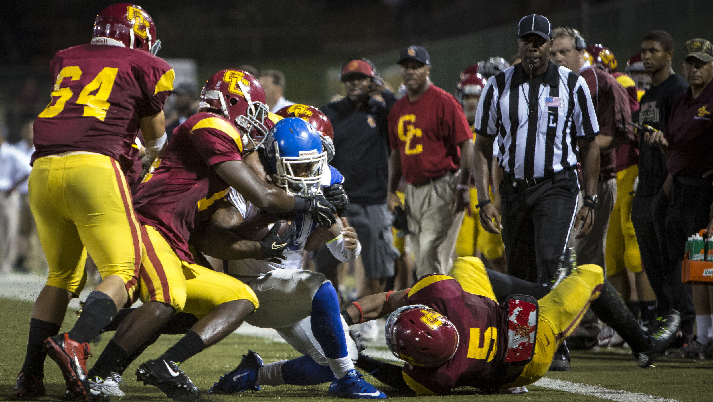  The Santa Monica College Corsairs men's football team sophmore running back #20 Rojer Jones (blue,center) ran for 22 yards on this play before this huge tackle from The Glendale College Vaquero's in an away game in Glendale, Calif. on October, 3rd 2