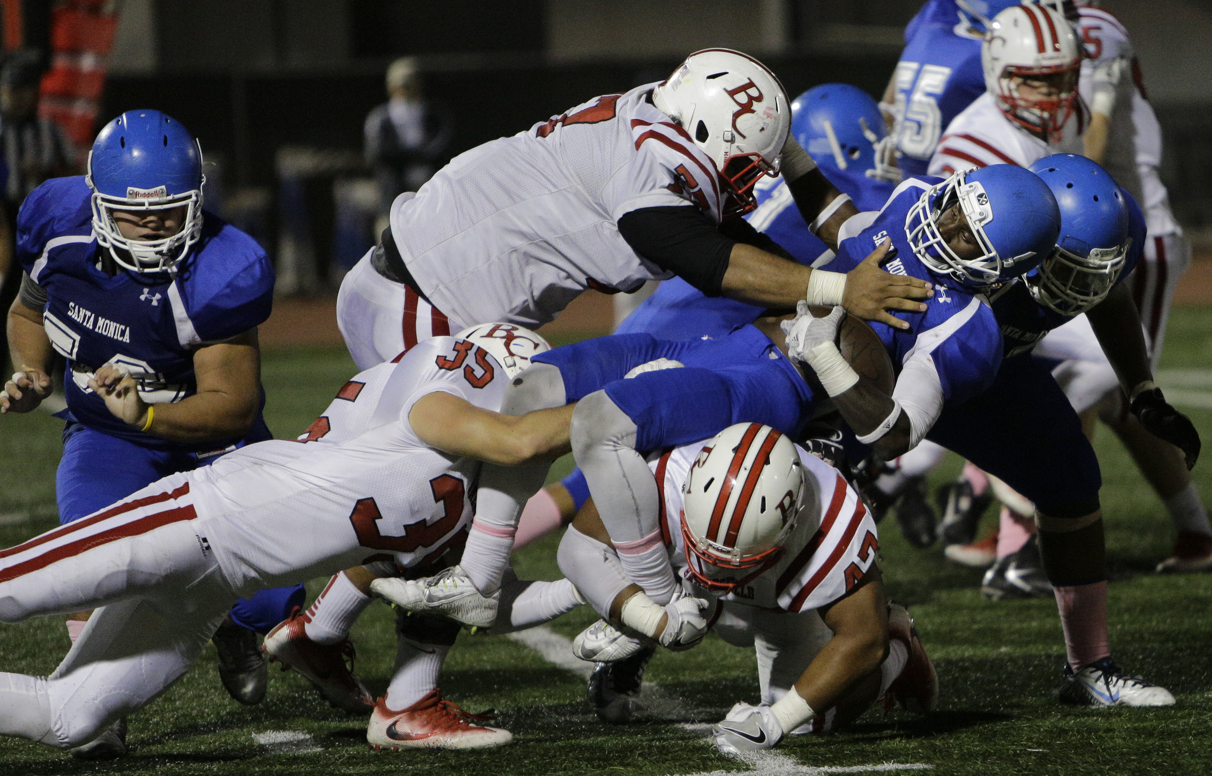  The Santa Monica College Corsair mens football team runningback (1) Kwame Duggins (blue,center)   makes a run for a first down but is stoped by the entire Bakersfiels College Renagades team during the Homecoming game in the 3rd quarter. The Corsairs