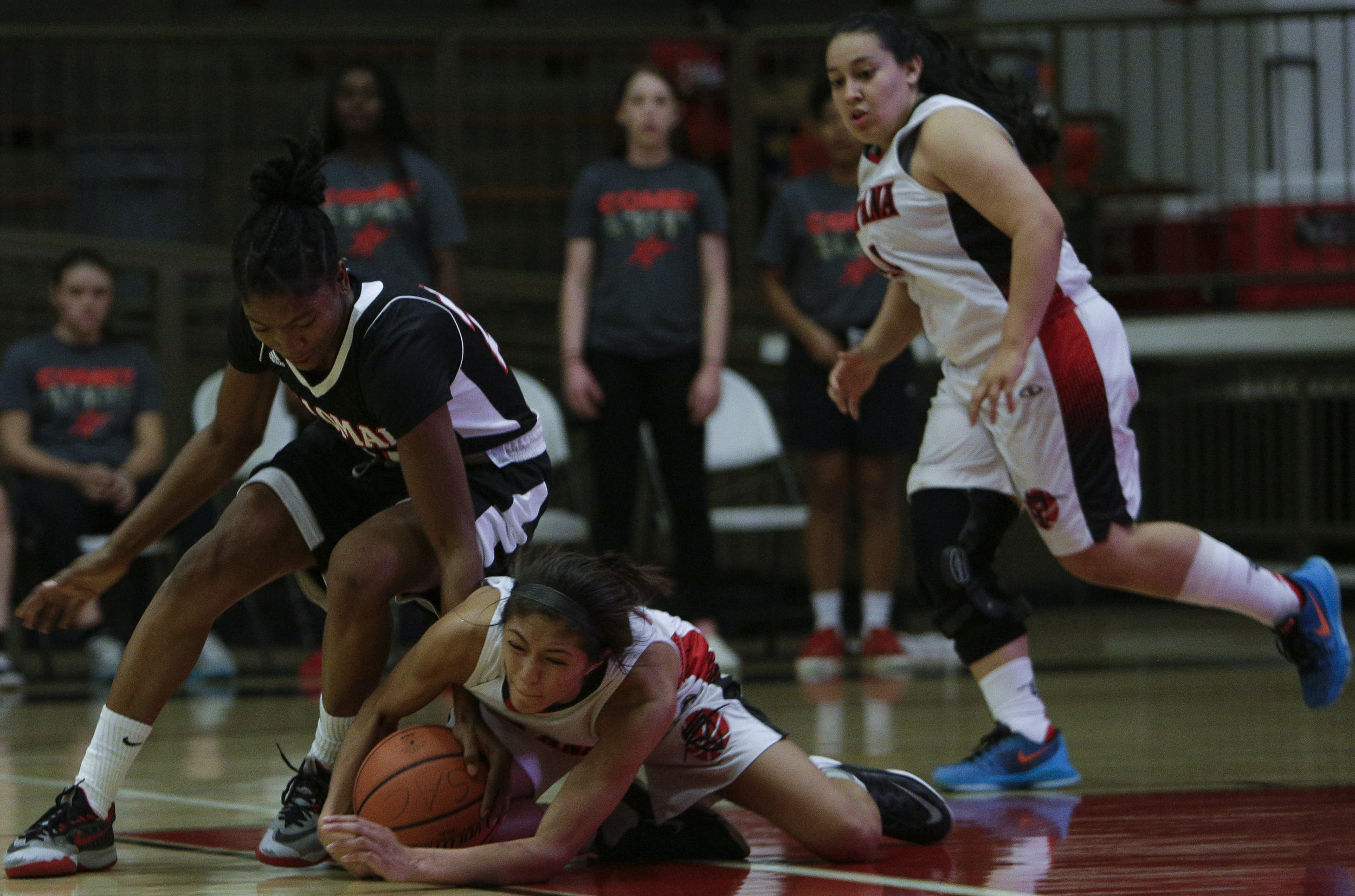  The Santa Ana College Dons womens basketball team sophmore guard (21) Lauren Fruto  (right) gets losses the ball and is forced into a tangle for possession of the ball by The Palomar Comets freshman guard (21) Regina Sheffield (left). The Dons would