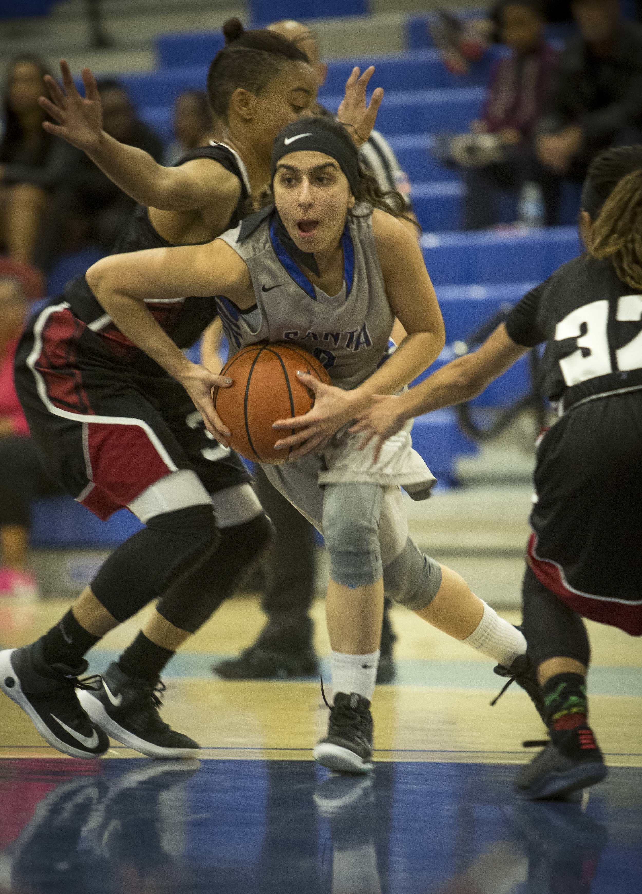  Feburary 22nd 2017 . The Santa Monica College Corsair Womens Basketball team freshman guard #2 Jessica Melamed goes up for a layup to score against The San Diego City College Knight's freshman guard #3 Justice Shortly (black,left), and sophomore gua