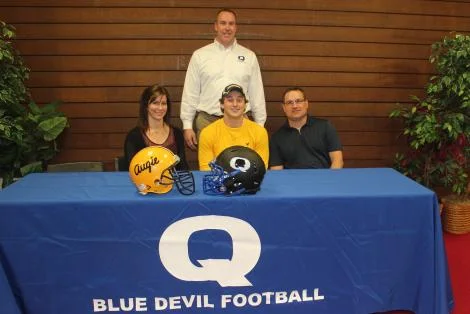 Bryce with his mom and dad and Coach Little