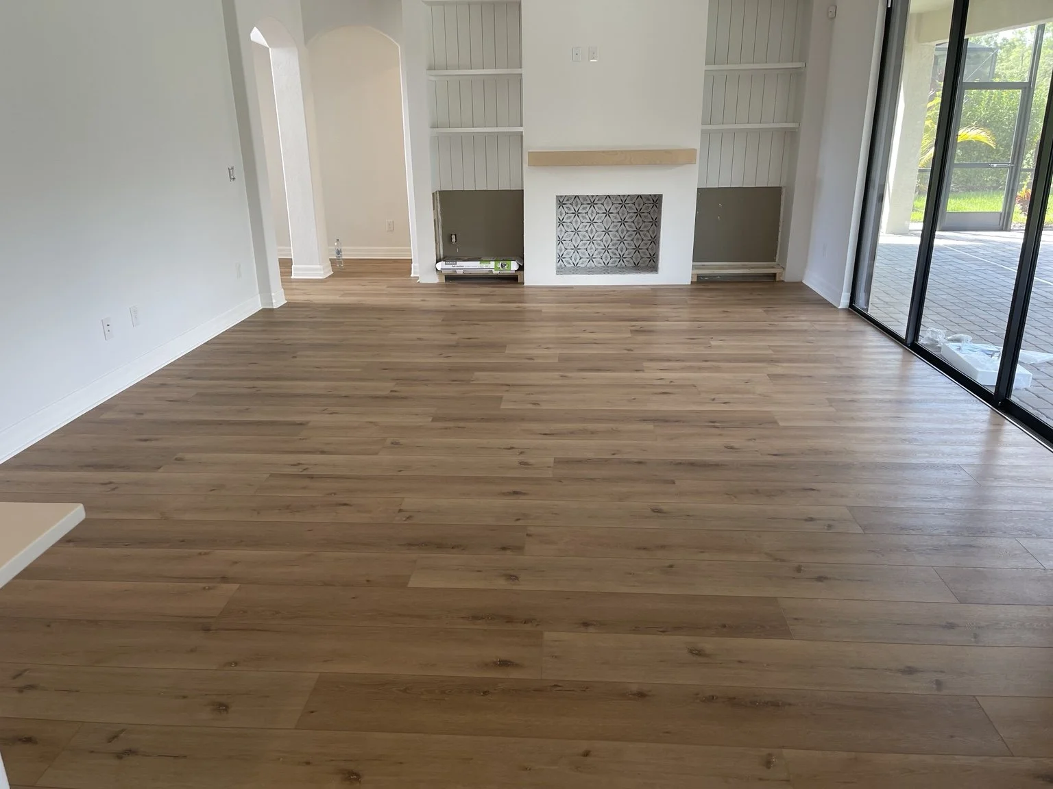 COREtec Cairo Oak luxury vinyl plank flooring installed by Cardinal Floors in a Polo Run living room in Lakewood Ranch