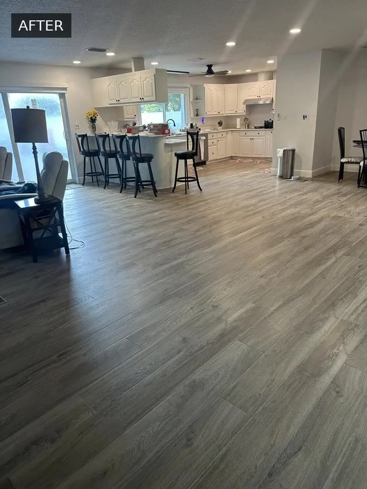 Completed wood-look flooring in an open living area and kitchen, shown in the Cardinal Floors before-and-after video