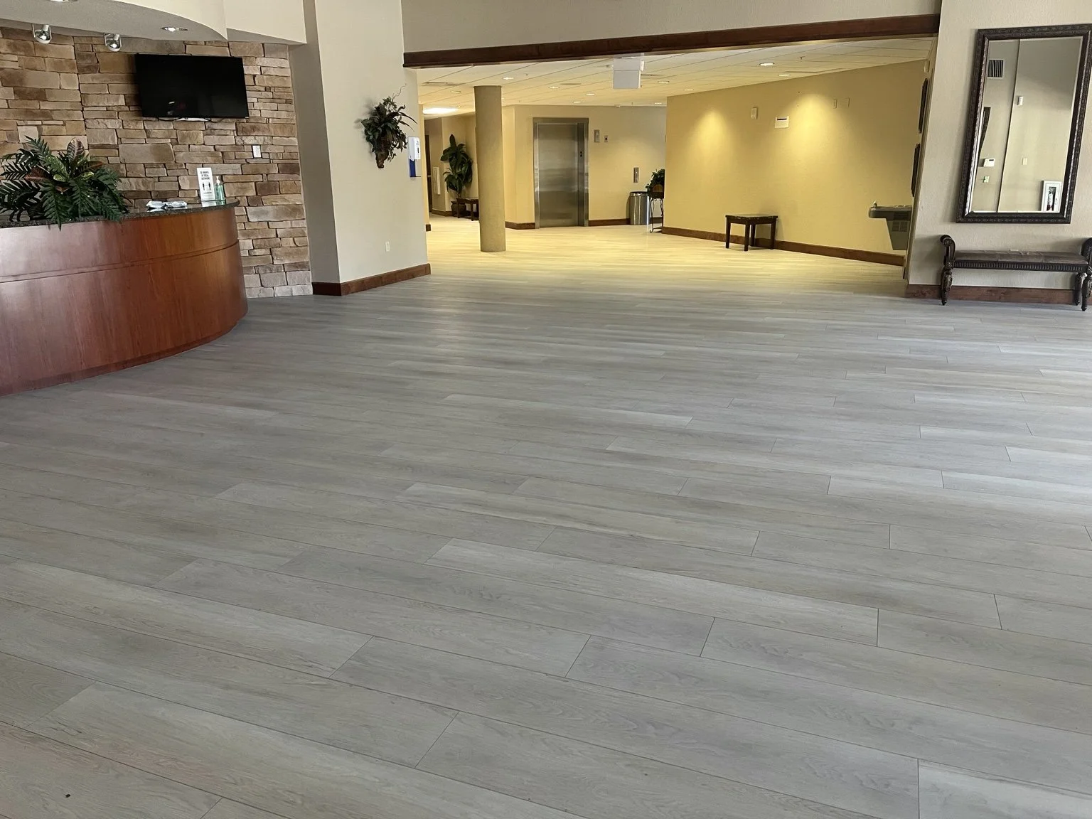 Light wood-look luxury vinyl flooring in the lobby of Lakewood Ranch Baptist Church in Lakewood Ranch.