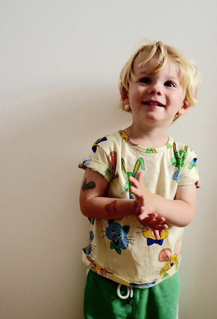 Austin wears Ducky Street tattoos, Mini Rodini t-shirt and H&M track pants (similar here )