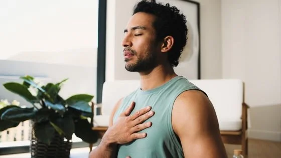 man holding chest indicating doing inner child work.
