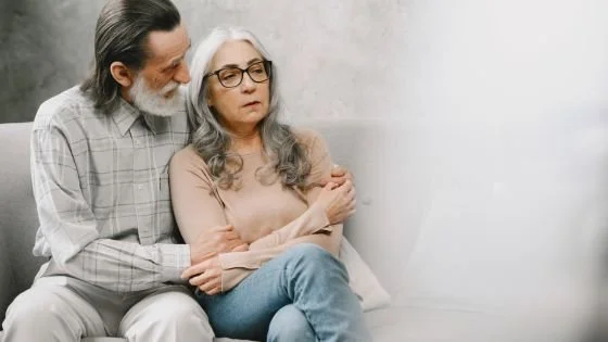 old man comforting old woman partner about need for natural aging and its impacts on their sex life.