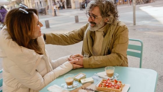 couple looking into each other's eyes and sharing a meal. Indicating a reconciliation.