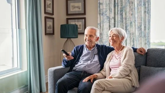 old couple watching show indicating value and longevity when sharing interests.