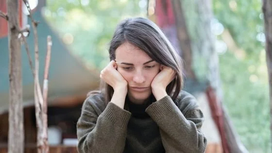distressed woman outside holiday event indicating grief during the holidays.