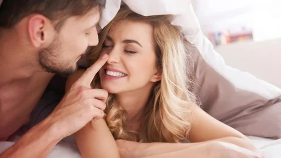 man booping woman' nose indicating ways of showing love.