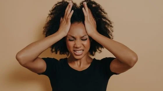 black woman looking distressed due to diagnoses and how they impact sex.