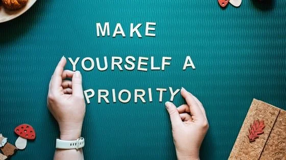 hands spelling make yourself a priority showing importance of relationship to self