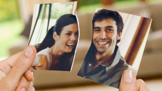 torn photo of two people indicating a separation.