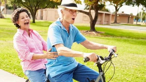 older couple riding bike together indicating moving forward in an intensive can help the longevity of a relationship.