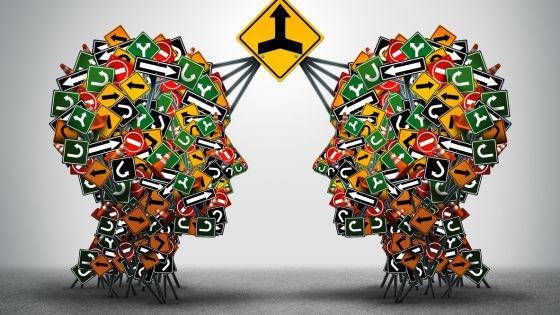 two heads with various direction signs converging to the same direction sign indicating mindful communication.