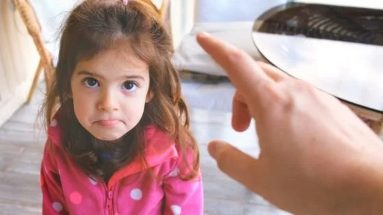 young girl being scolded indicating power dynamics.