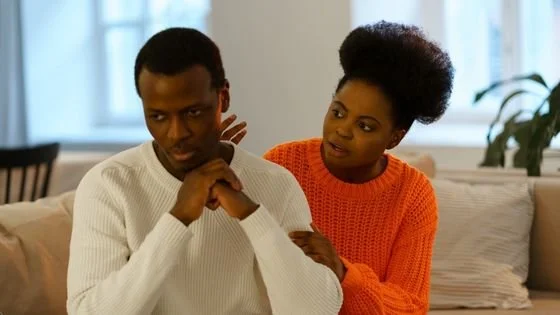 man upset with woman partner trying to comfort him based on assumptions he made about her intent. Checking assumptions can be learned in couples counseling.