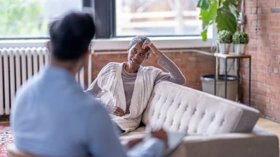 male therapist sitting with black woman client building rapport through honest feedback. These skills can be learned in therapy.