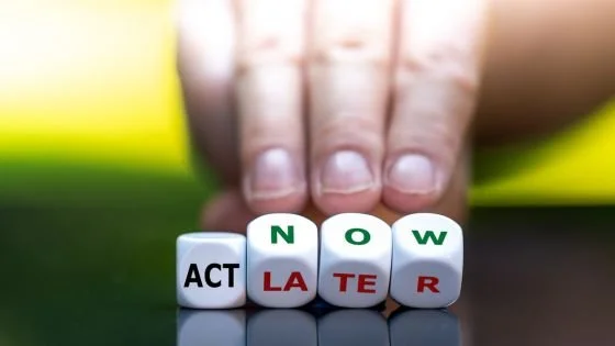 hands with letters spelling act now/later indicating how we can choose the appropriate timing to address something.