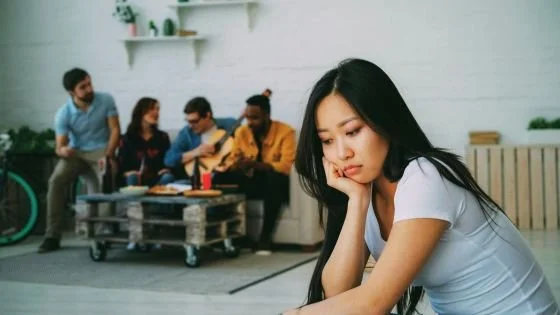woman self-excluding because she has struggles she's unwilling to share. Learning to open up in timely ways can be done in couples counseling.