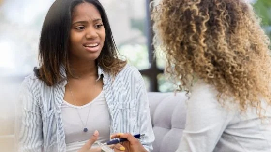 woman confiding that she needs time to process and is feeling overwhelmed or flooded.