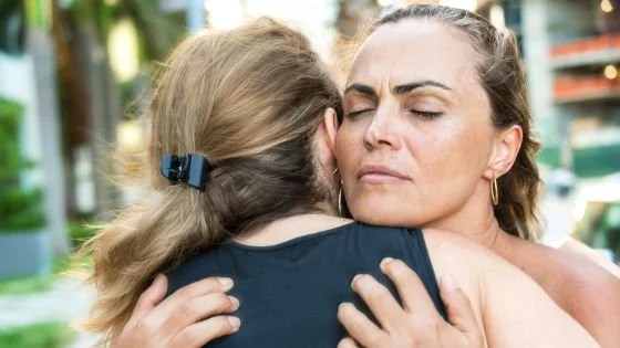 woman hugging and looking reverential about the connection indicating how we can honor the relationship ending in couples therapy.