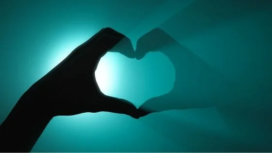 hand heart reflection indicating self-love.