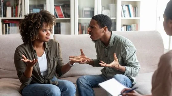 couple arguing in front of therapist indicating showing up as you are so the therapist can jump in and go deeper.