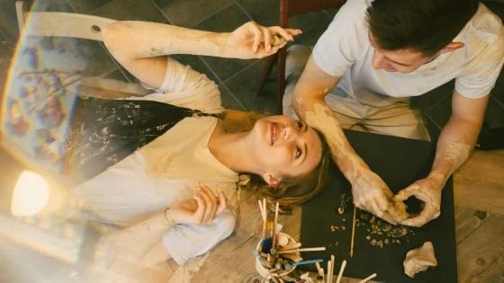 couple playing with clay together, representing emergent co-creation.