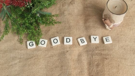 word tiles spelling goodbye on a burlap table and how we can honor the relationship ending in couples therapy.