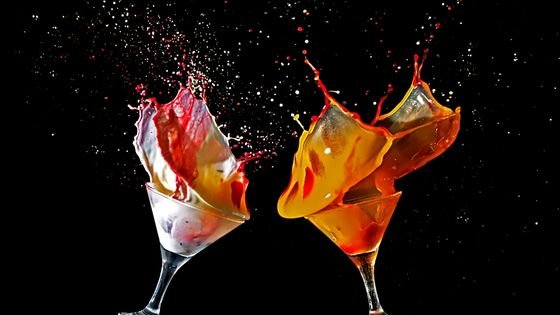 cocktail glasses with messy paint sloshing indicating messiness of new relationship energy