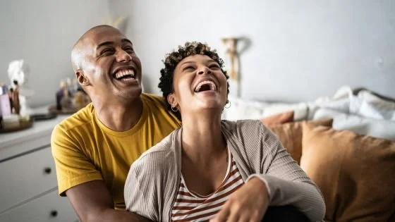 couple laughing together indicating mutual acceptance.