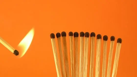 a lit match next to a bunch of matchsticks indicating clarifying threat awareness with your partner. This can be discussed in couples therapy.