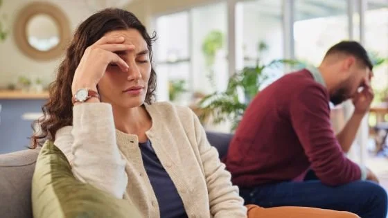 couple on couch sharing space yet feeling disconnected.