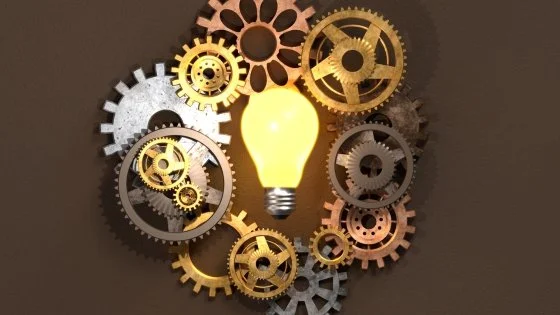 cogs, gears, and a lightbulb symbolizing the isomorphic process.