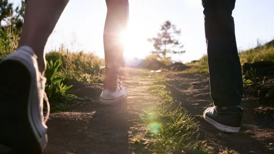 couple walking together indicating adjusting to the different pace of a couples intensive.