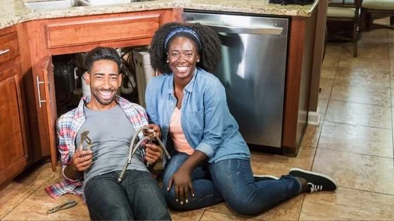 couple fixing something together indicating work after a couples intensive.