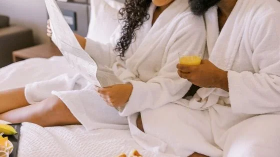 couple having breakfast in bed indicating celebrating love at a hotel.