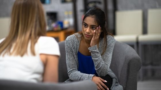an individual woman sitting with a therapist, ready to do the work.