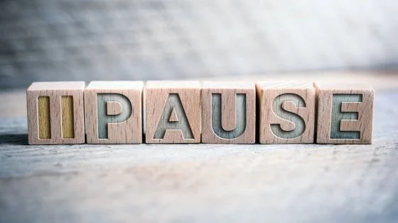 blocks that spell pause and pause symbol indicating the power of pausing during conflict.