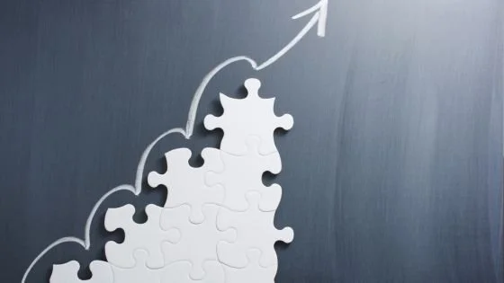 puzzle pieces with arrow symbolizes building routines that fit with consistency.