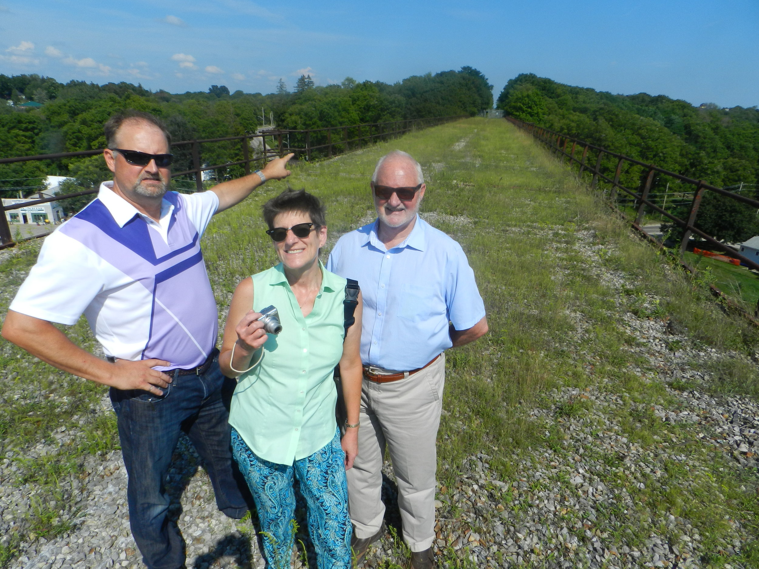 On Track board member (left) tours the MCR bridge with planning consultants Eve Holberg and Peter Smith.
