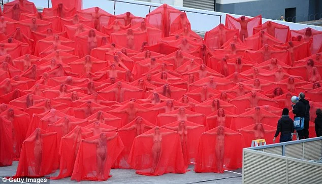 Hundreds of people have bared their private parts in frosty conditions in the name of art. About 500 converged in Melbourne Monday morning for the second of US artist Spencer Tunick's mass nude photo shoots for the Provocare Festival of the Arts. Temperatures hovered around nine degrees as hundreds made their way towards the Prahran Woolworths rooftop carpark, on Chapel Street in the inner city. 