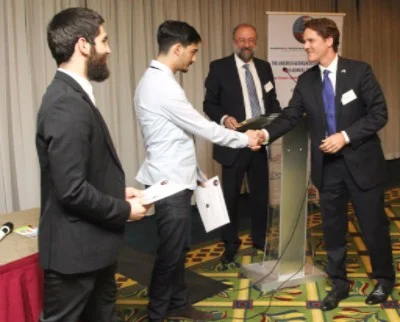 Robert Powell, Chief Legal Officer of Georgian American Alloys (GAA) presents the second place prize to Nebula Ltd. 