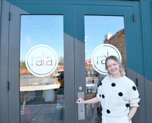 Alaina of Cold Gold poses smiling in front of Rala storefront  